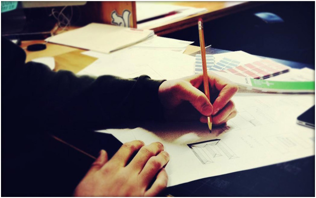 Photograph of one of our designers sketching design concepts.