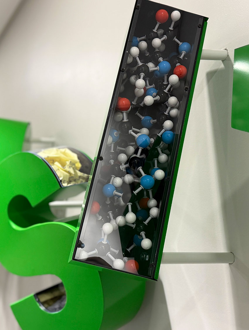 Colorful molecular model display with green support, showcasing scientific elements.